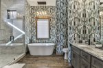 Master bathroom with walk-in shower and soaking tub